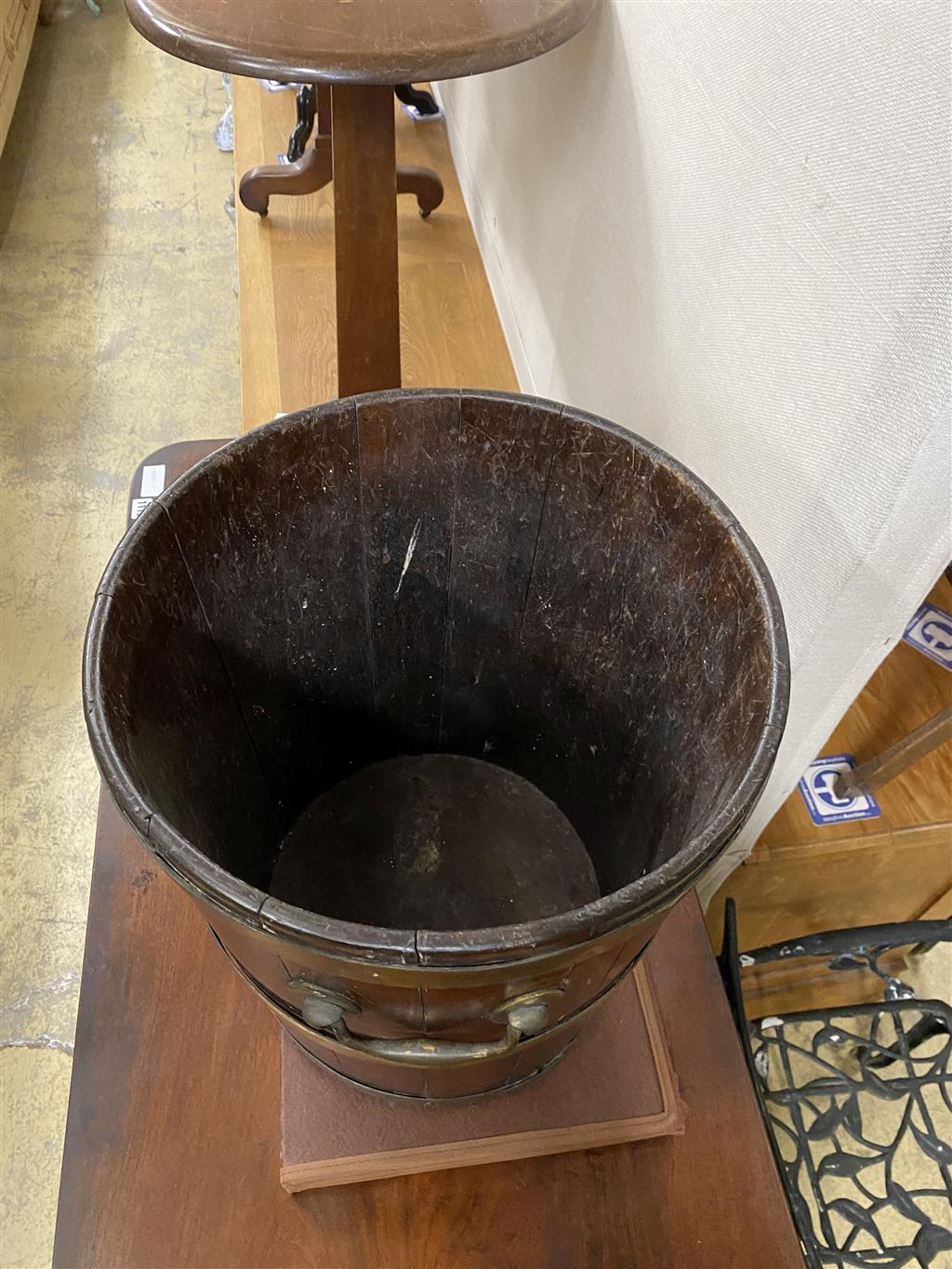 A George III circular brass bound mahogany peat bucket, fitted with two carrying handles, diameter 35.6cm, height 41cm